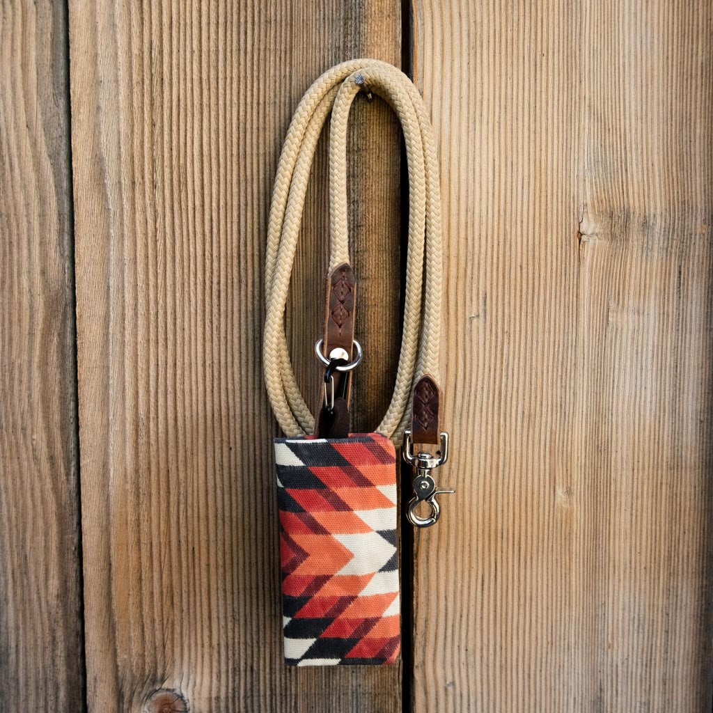 colorful travel dog bowl clipped to tan dog leash